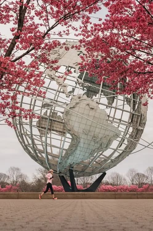 A woman jogging past the Unisphere in Queens